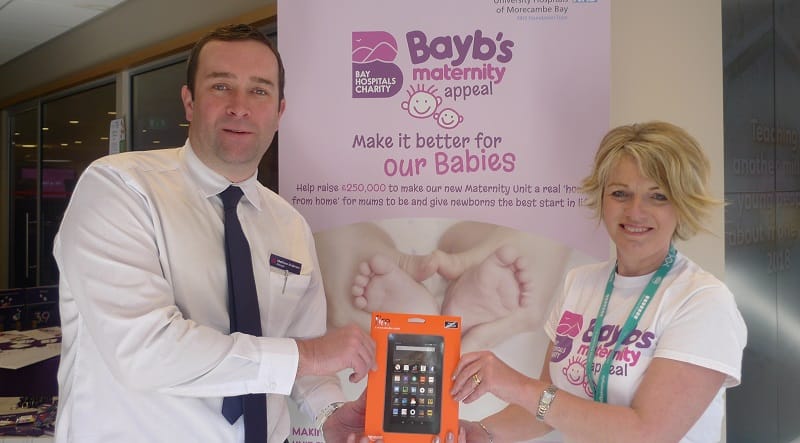 A “novel” way to support the Bayb’s Maternity Appeal, Matthew Anderson, manager of Barrow’s branch of the NatWest presents Bayb’s co-ordinator Heidi Bowron with a Kindle e-reader