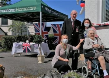 Villagers applaud couple at special VE Day tea party