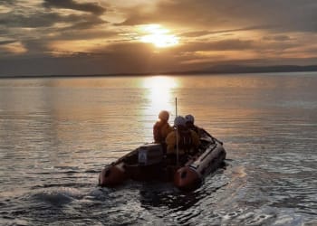 RNLI volunteers launch to multiple groups of people cut of by the incoming tide