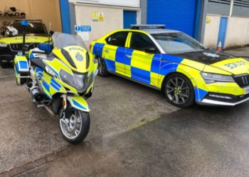 A Cumbria police motorbike and car pictured side by side with another pictured in the garage behind