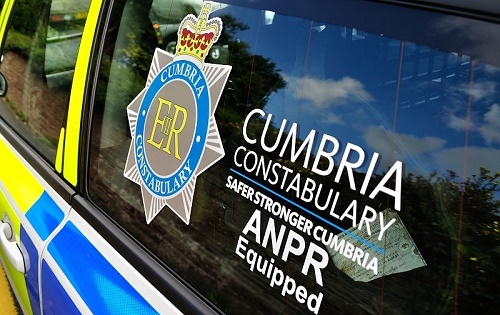 A police car window viewed from the side with a Cumbria Constabulary logo accompanied by the words Safer Stronger Cumbria