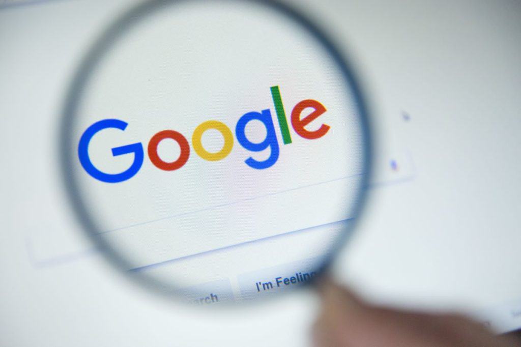 Magnifying glass over Google logo