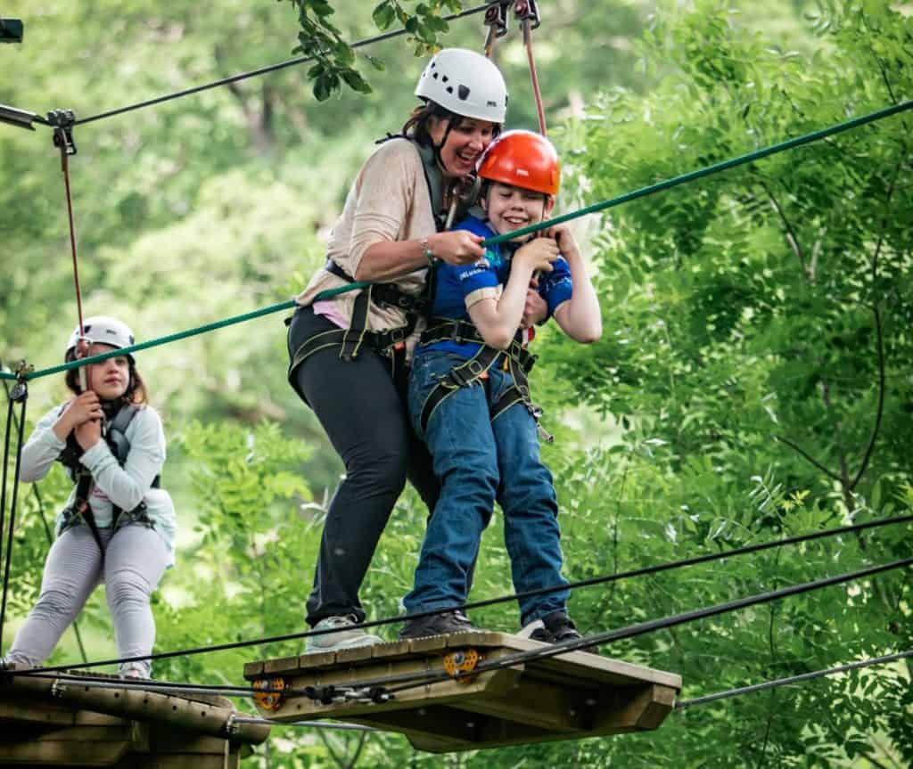 Oliver Voysey supported by mum Sarah and watched over by sister Elizabeth, aces the Calvert Lakes high ropes course at the Lake District Calvert Trust 