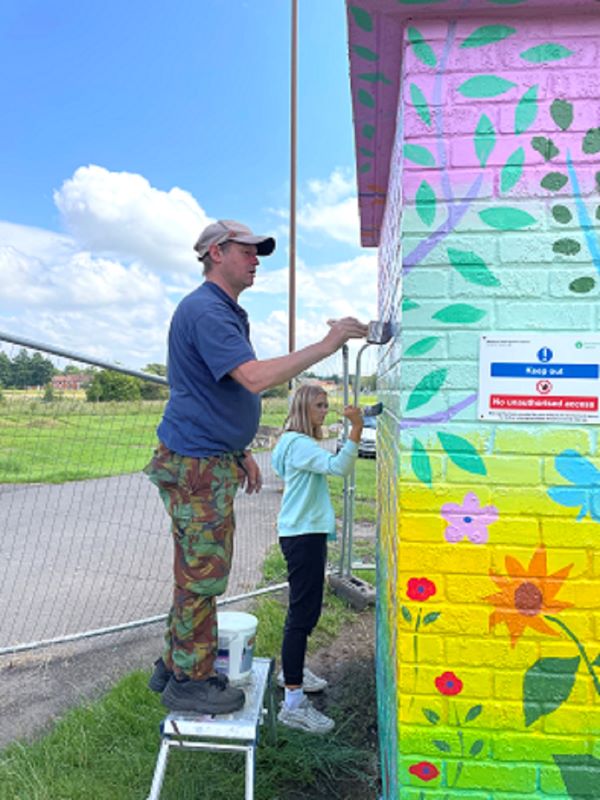 Volunteers paint the Melbourne Park Gauging Station