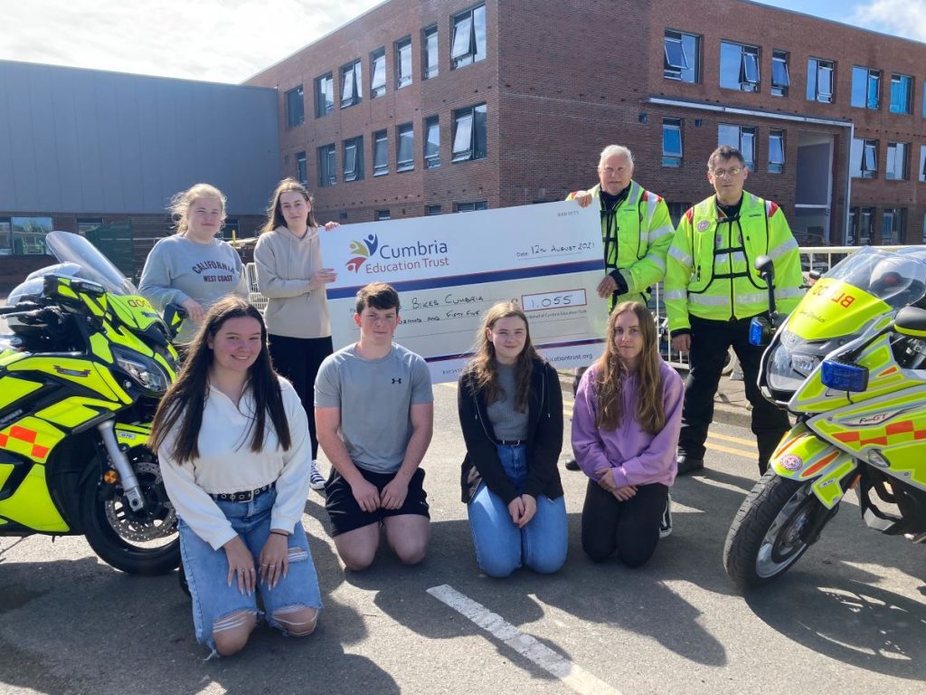 The Whitehaven Academy students handing over their cheque for £1,055 to Blood Bikes Cumbria