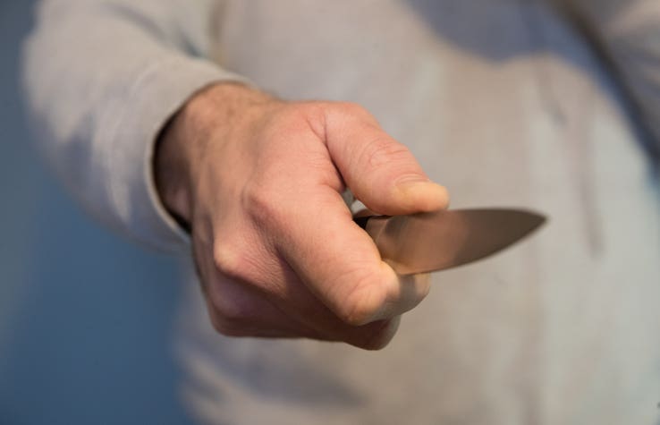 man pointing knife 