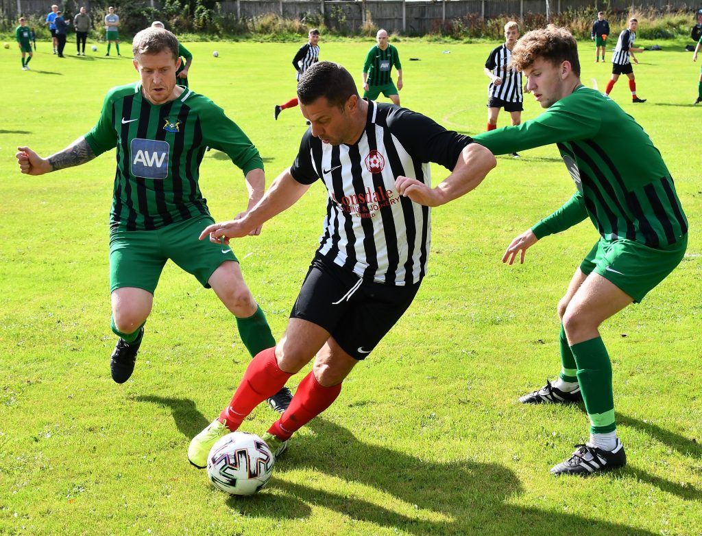 Dearham's Steven Stoddart holds off Deer Orchard's Brian Straughton and Louis Pickering 