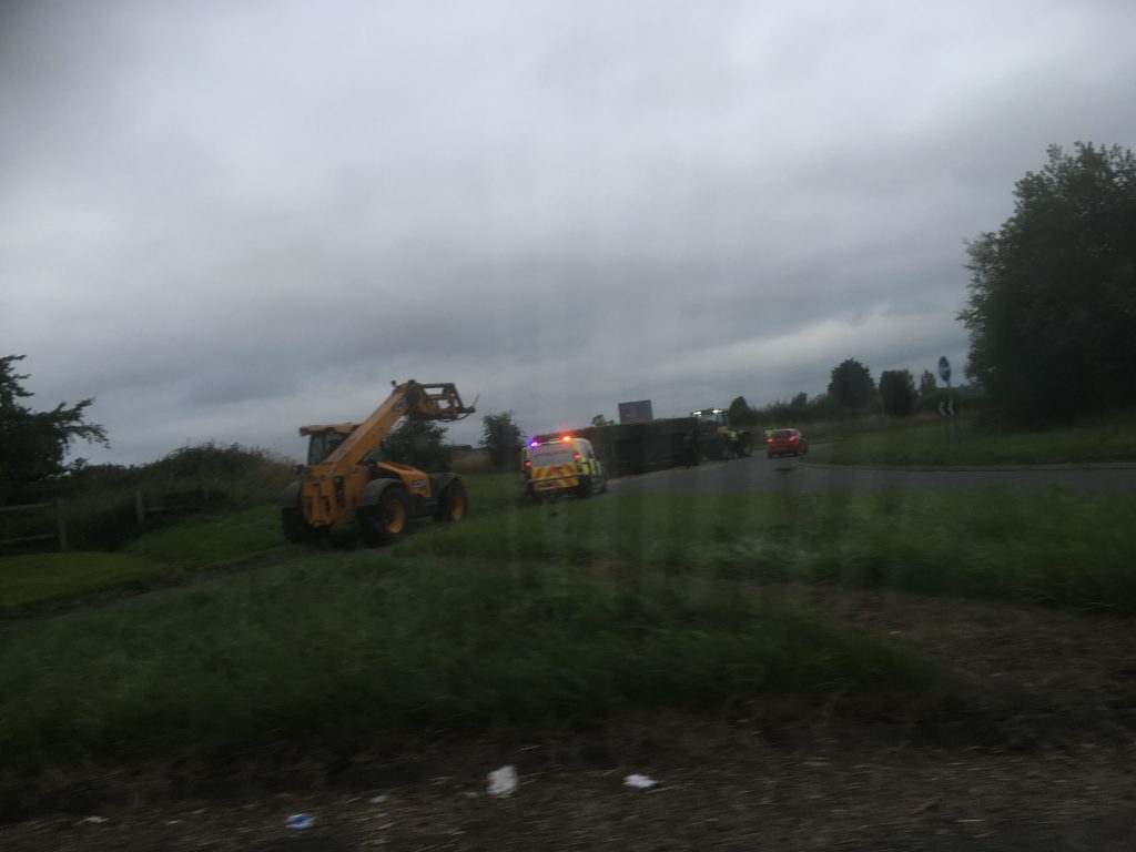 A tractor has shed a trailer full of hay on a roundabout near Penrith.