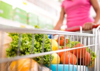 woman pushing shopping trolley