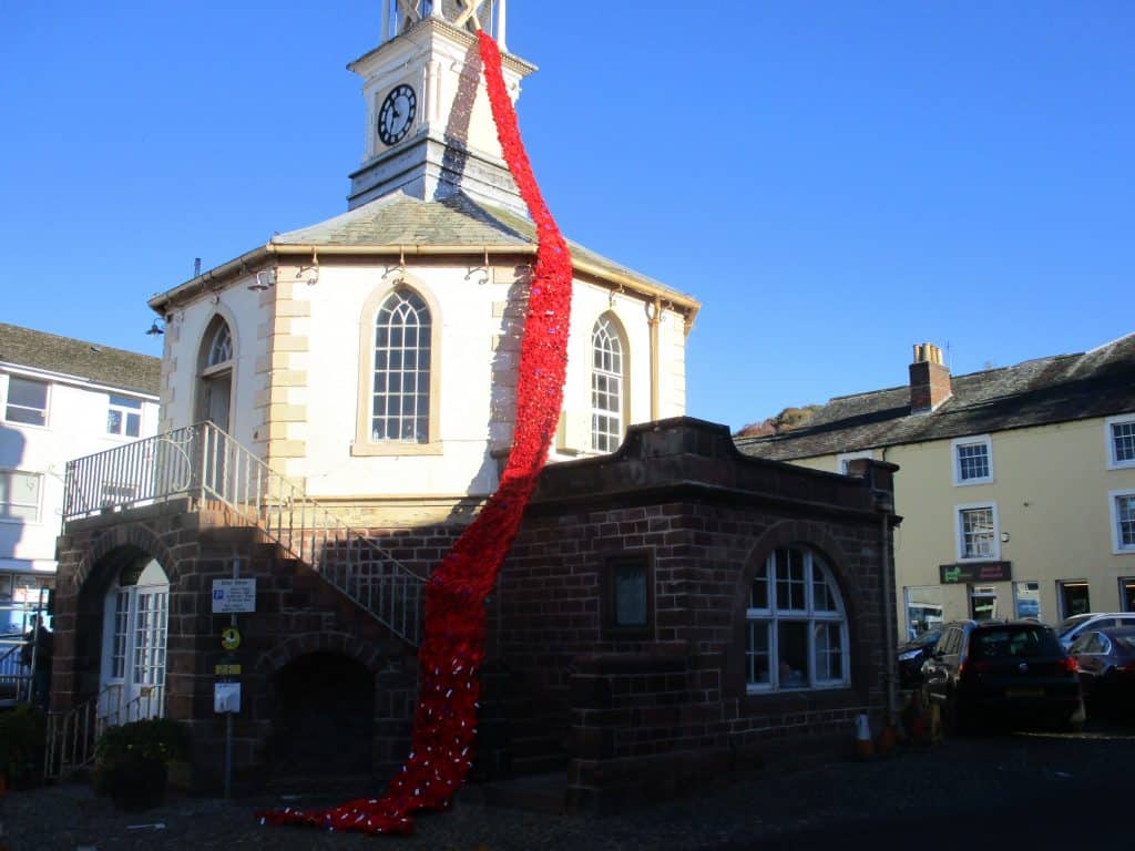 Brampton's historic Moot Hall has again been bedecked in a cascade of knitted red and purple poppies reaching from high on the clock tower right down to the ground, there are also tags on some of the poppies containing the name of people from Brampton who lost their lives in the conflicts. Picture: Paul Grindley