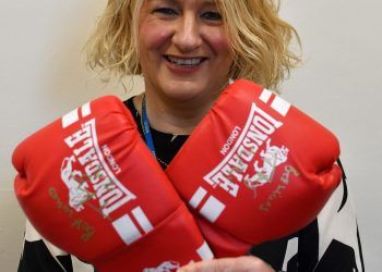 Christine Metcalfe of Bay Hospitals Charity with the gloves signed by world heavyweight champ Tyson Fury.