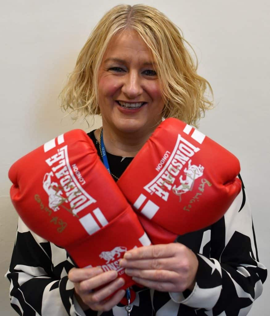 Christine Metcalfe of Bay Hospitals Charity with the gloves signed by world heavyweight champ Tyson Fury.