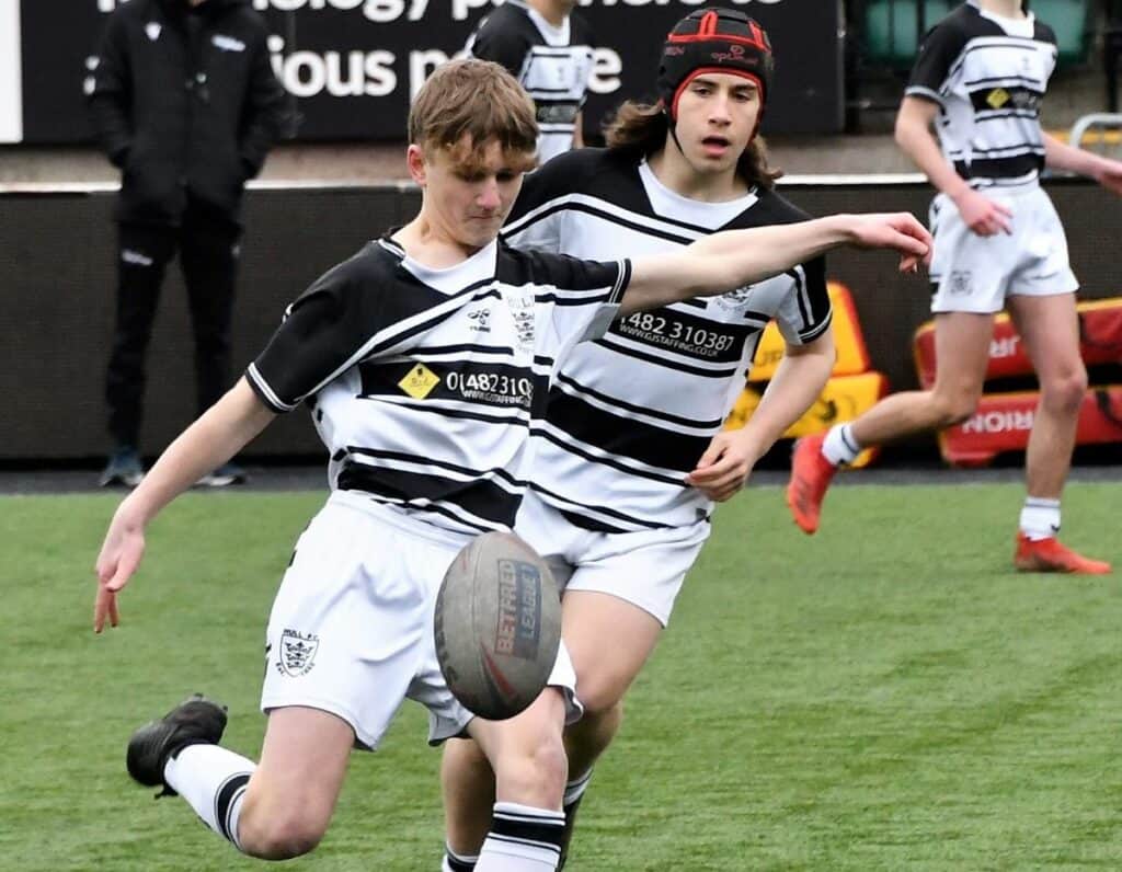 West Cumbria Development's Danny Stables launches a kick forwards. Picture: Ben Challis