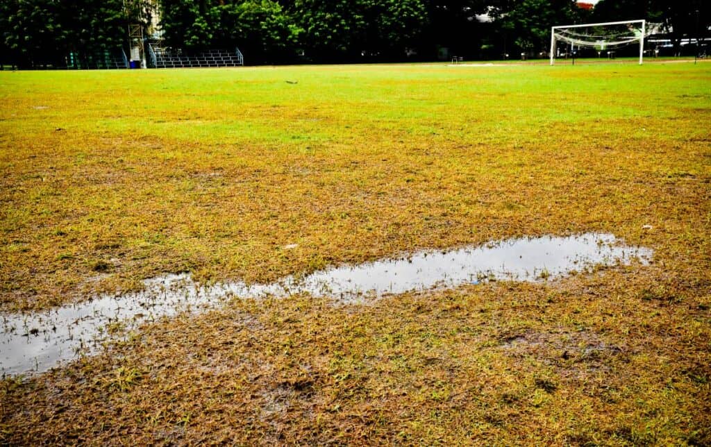 A waterlogged football pitch with a goal on the right of the picture