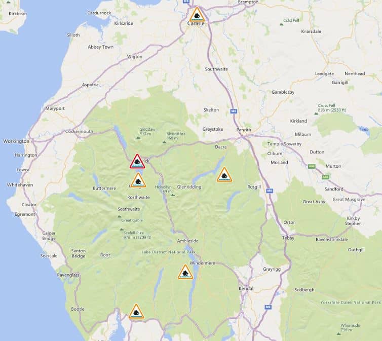 A map shows the areas where flood warnings or alerts are in force in Cumbria. A yellow triangle with a house inside and water below it indicates a flood alert. A red version of the triangle is used for flood warnings