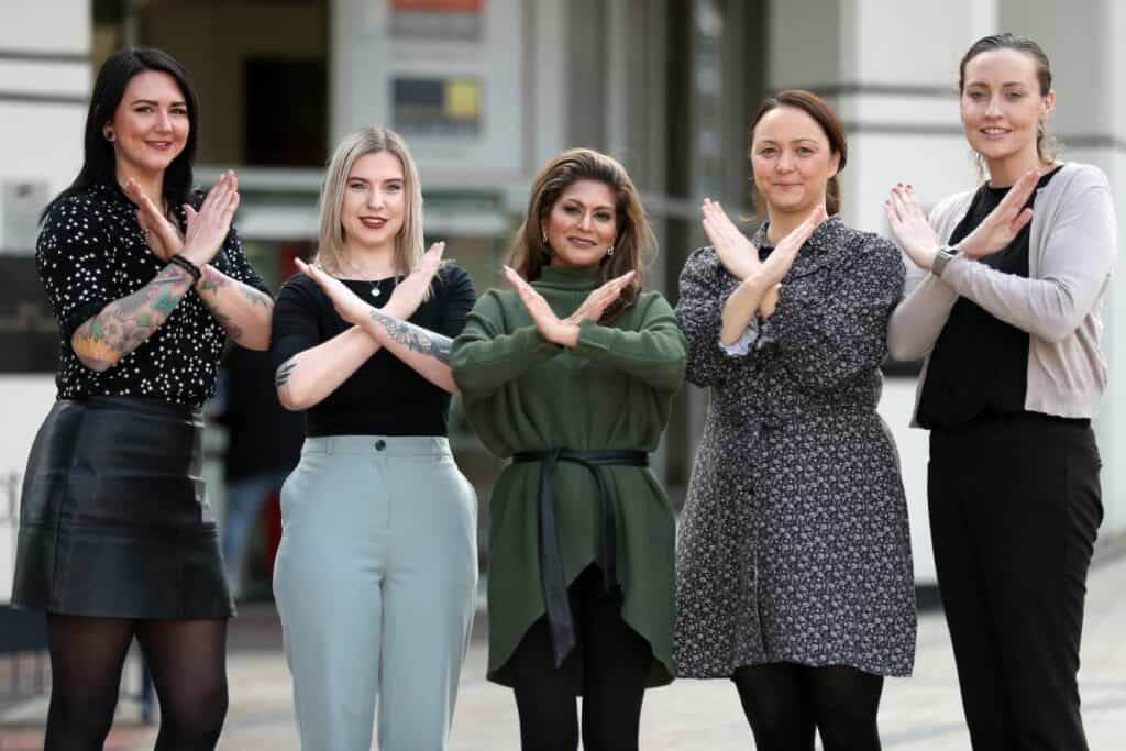 Avanti West Coast International Women's Day control team. (L-R): Amy Bellamy, Liane McMahon, Nitu Kapila, Rachel Hartill, Lisa Healy. They all poses with hands making a cross an X shape