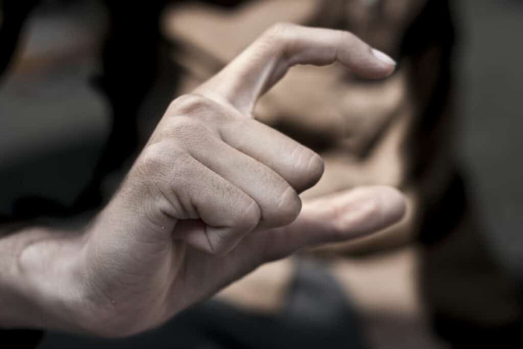 Person signing C in British Sign Language