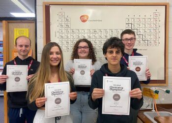 Chemistry Olympiad award-winners at Barrow Sixth Form College hold their certificates with pride as they have their pictures taken together