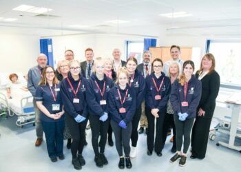 Students from Furness College pictured with Alex back left in the hospital bed
