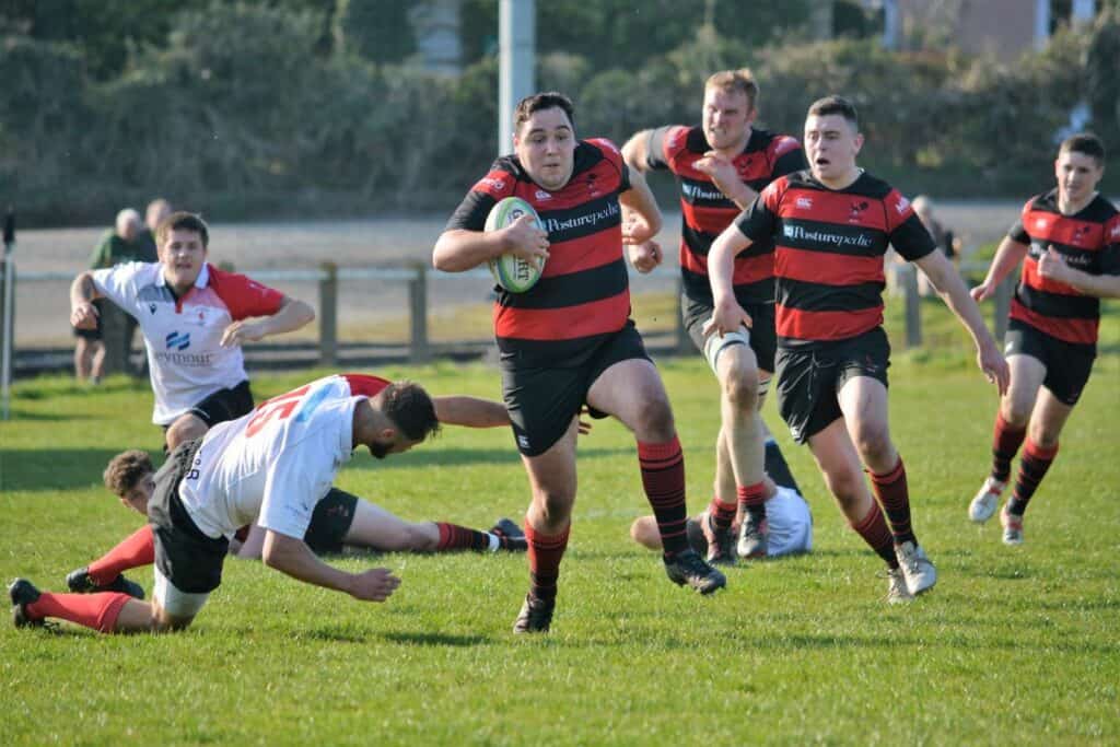 Hooker Adam Cavanagh races away for a fine individual try as Hartlepool Rovers players can be seen on the floor in their efforts to stop him