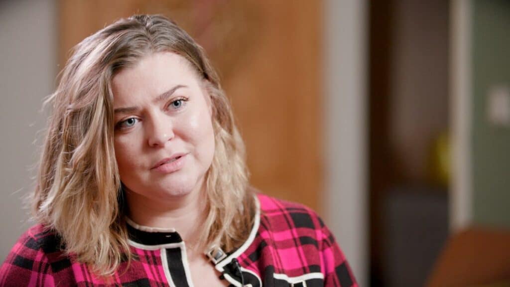 Romany Gypsy Lena McAllister, from Carlisle, who appears in the Macmillan film. She has blonde hair and is wearing a pink and blacked checkered shirt