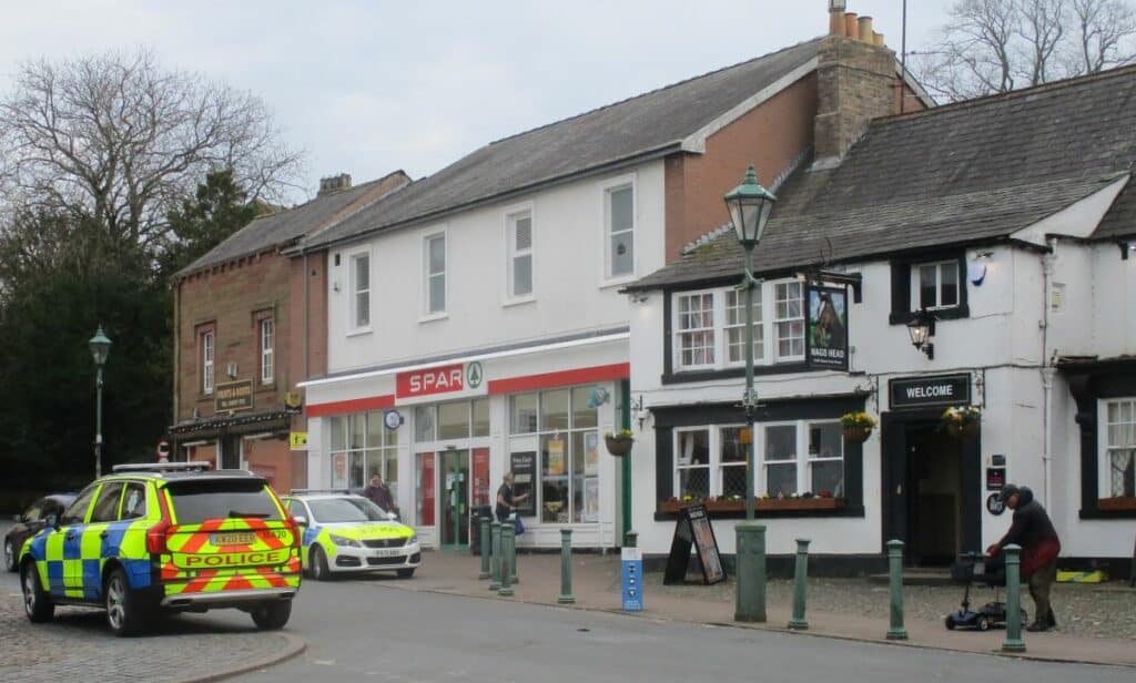 Two police cars attend Front Street in Brampton. One is parked outside Spar and the other directly opposite