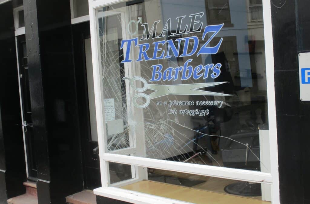 The damage caused to Male Trendz barbershop in Brampton. Damage has been caused to the glass but has not completely smashed