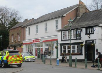 Two police cars attend Front Street in Brampton. One is parked outside Spar and the other directly opposite