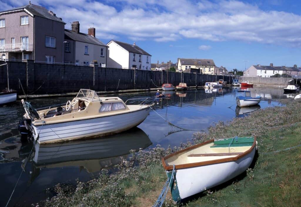 A picture of boats in the water at Haverigg with houses all around the edge of the water