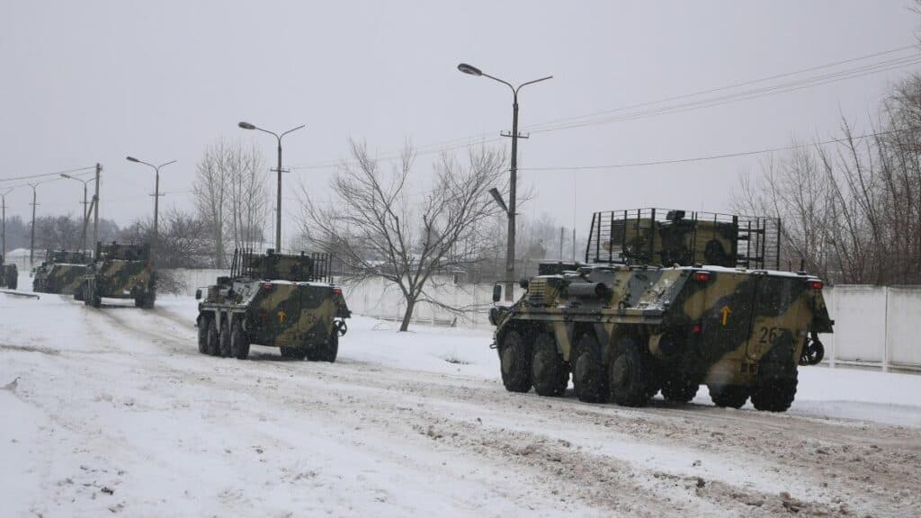 A column of armoured personnel carriers rides on a winter road. Ukraine prepares to defend its country from the Russian invasion