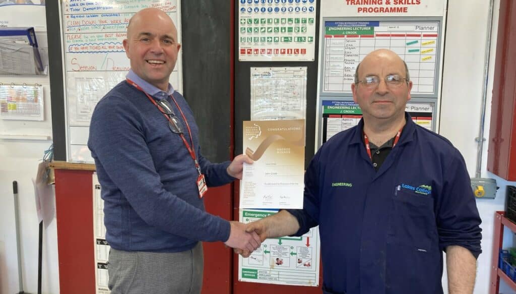 John Crook, who teaches engineering at Lakes College, being awarded a Bronze Pearson National Teaching Award for Further Education Lecturer of the Year by assistant principal Daniel Braithwaite.
