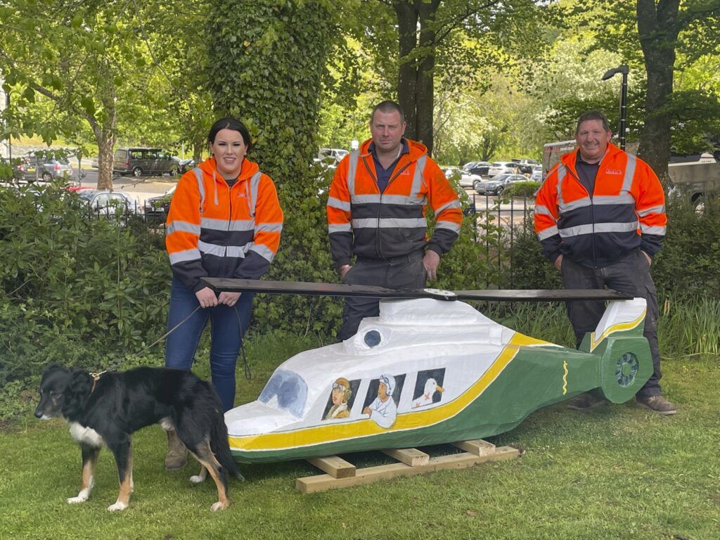 Amy, Ben and Peter from B.A.F. Contracting with the helicopter in Keswick