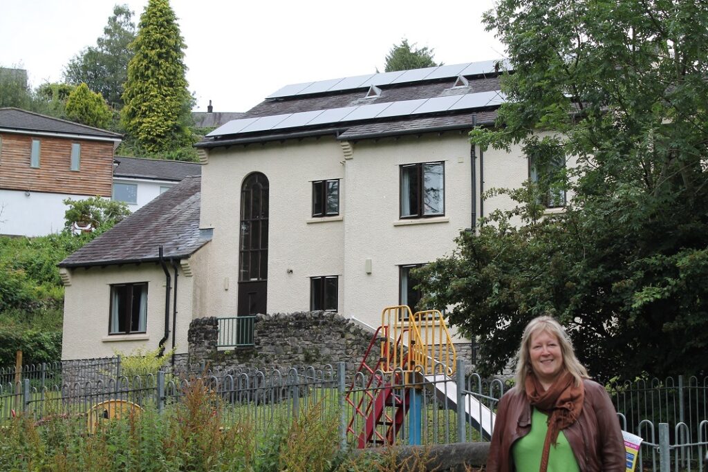 Councillor Dyan Jones pictured with the solar panels on Town View Fields hostel in Kendal