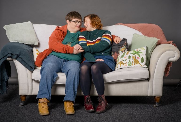 Ralph & Katie sitting on sofa