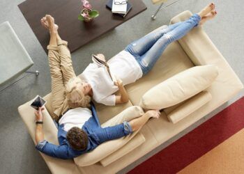 man and woman relaxing on sofa